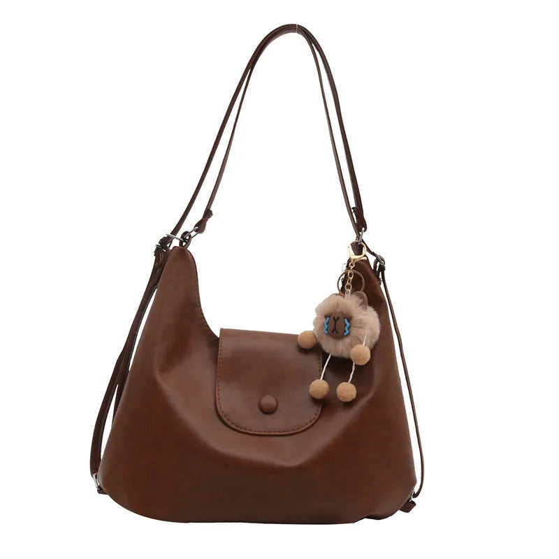 Textured PU leather commuter backpack with single shoulder strap and internal mobile phone pocket
