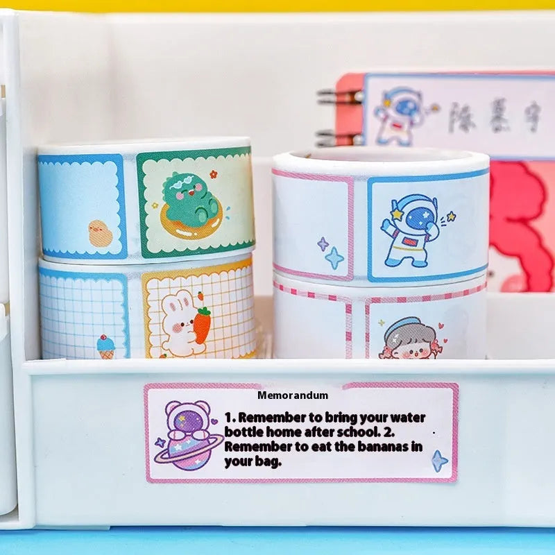 Roll of cartoon name tape stickers showing dinosaur, astronaut, rabbit, and girl designs.