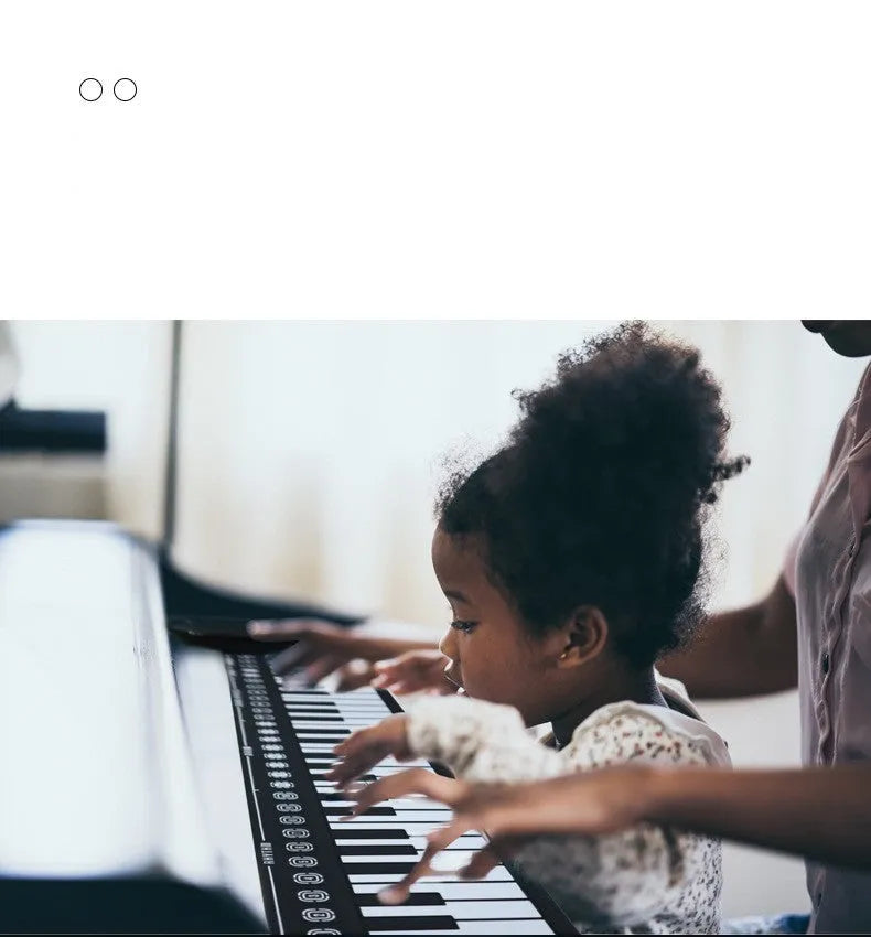 49 key portable folding electronic keyboard in pearl white, showing compact folded size next to unfolded playing position