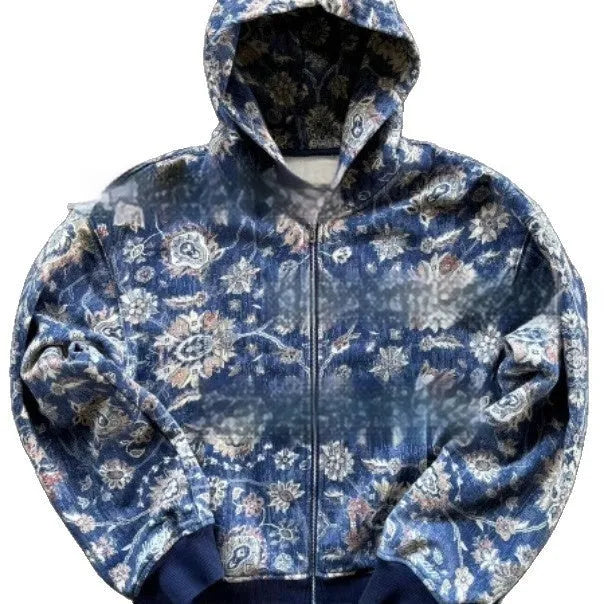 A man's loose fitting blue hooded zip-up coat with long sleeves on a hanger.