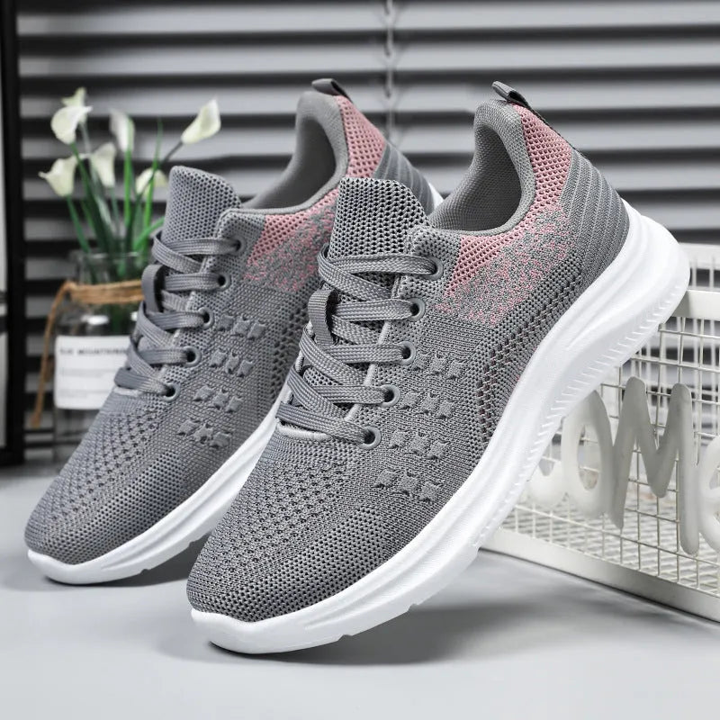 Women's black mesh sneakers with round toe and lace-up front on soft PVC sole