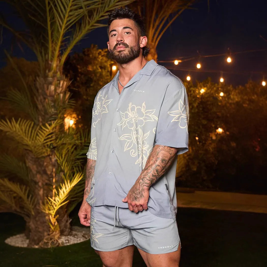 A man's loose grey short-sleeved cardigan with a floral print, showing the elastic band fabric.