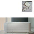 Black and white ultrasonic flame air humidifier and aroma diffuser with LED lights on a table.
