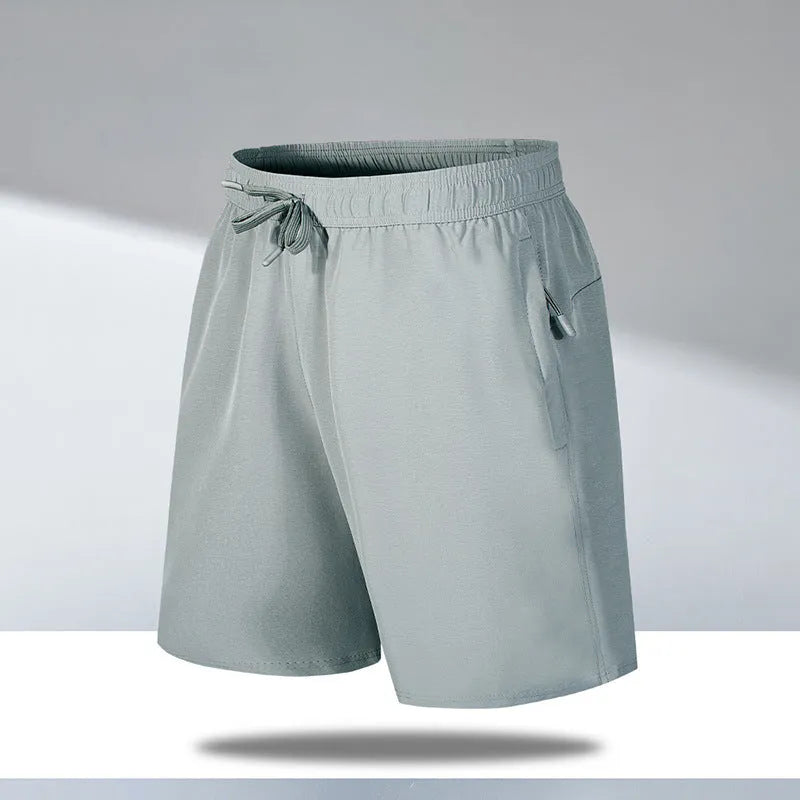 Man wearing loose-fit black quick-dry sports shorts made from ice silk polyester fabric.