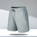 Man wearing loose-fit black quick-dry sports shorts made from ice silk polyester fabric.
