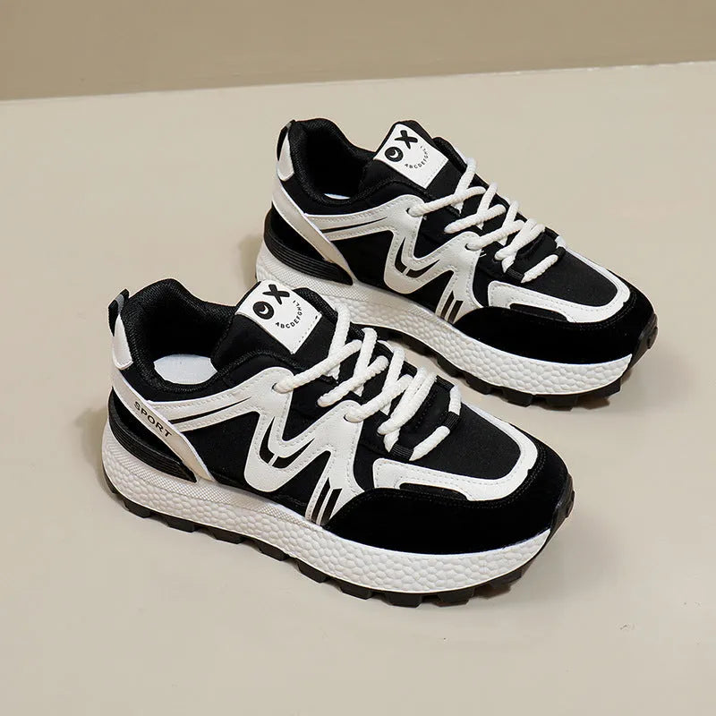 Women's black platform casual shoes with round toe and front lace-up design on a neutral background.