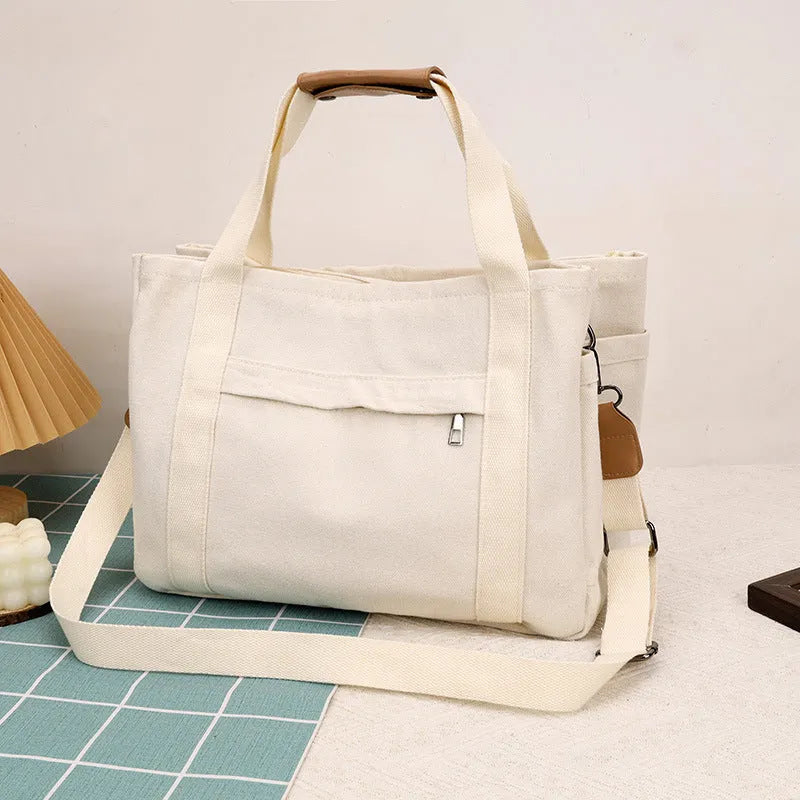 Women's large capacity canvas crossbody tote bag with organiser pockets in black colour