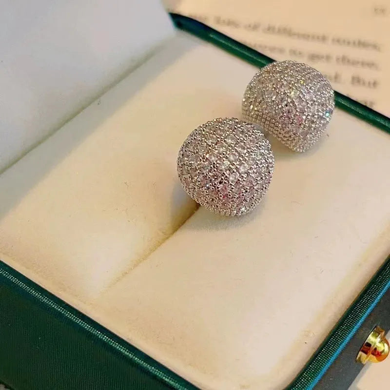 Geometric drop-shaped diamond ear clip earrings in gold and white colours with spherical elements