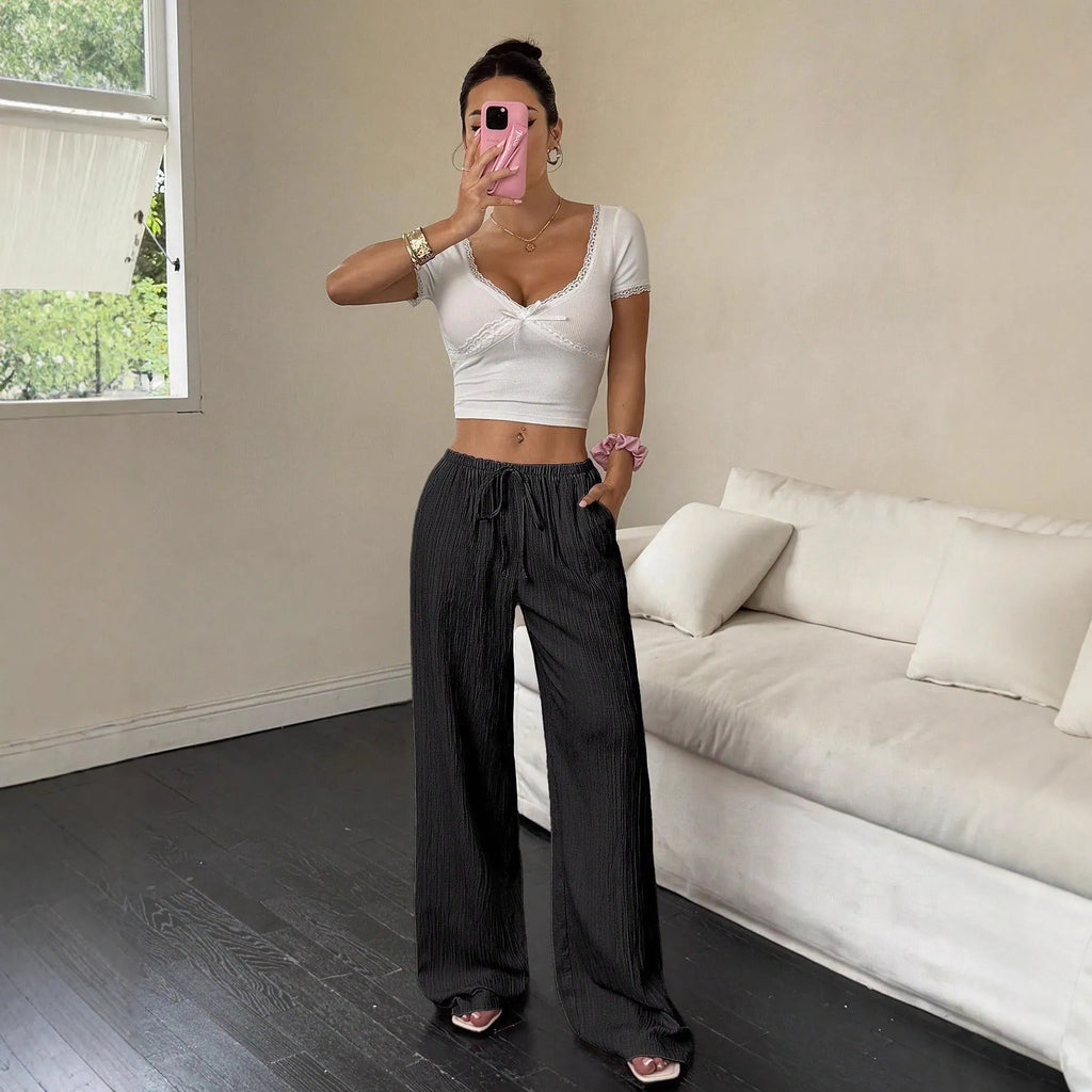 Women's black wide leg trousers with lace-up waist trimming detail on mid waist