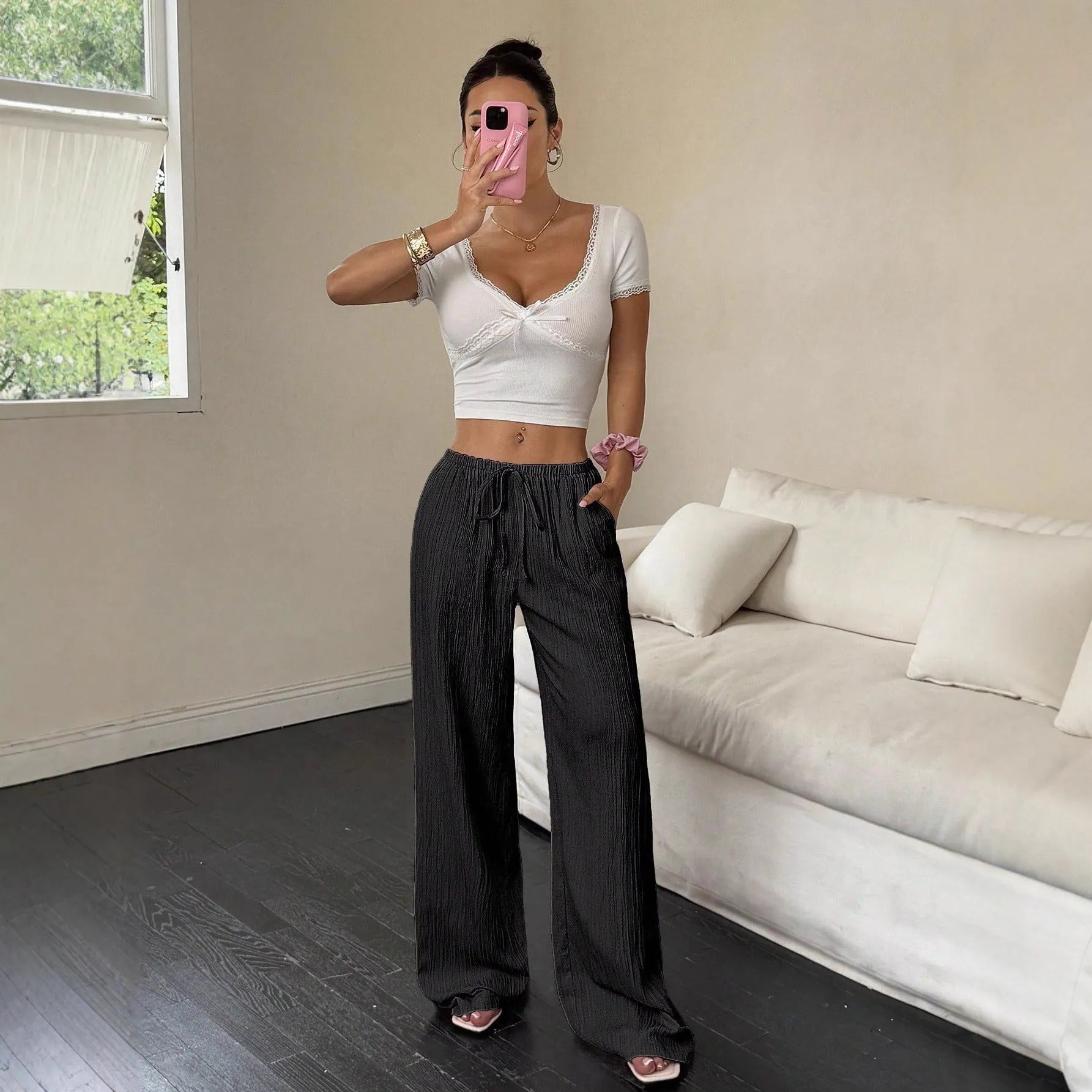 Women's black wide leg trousers with lace-up waist trimming detail on mid waist