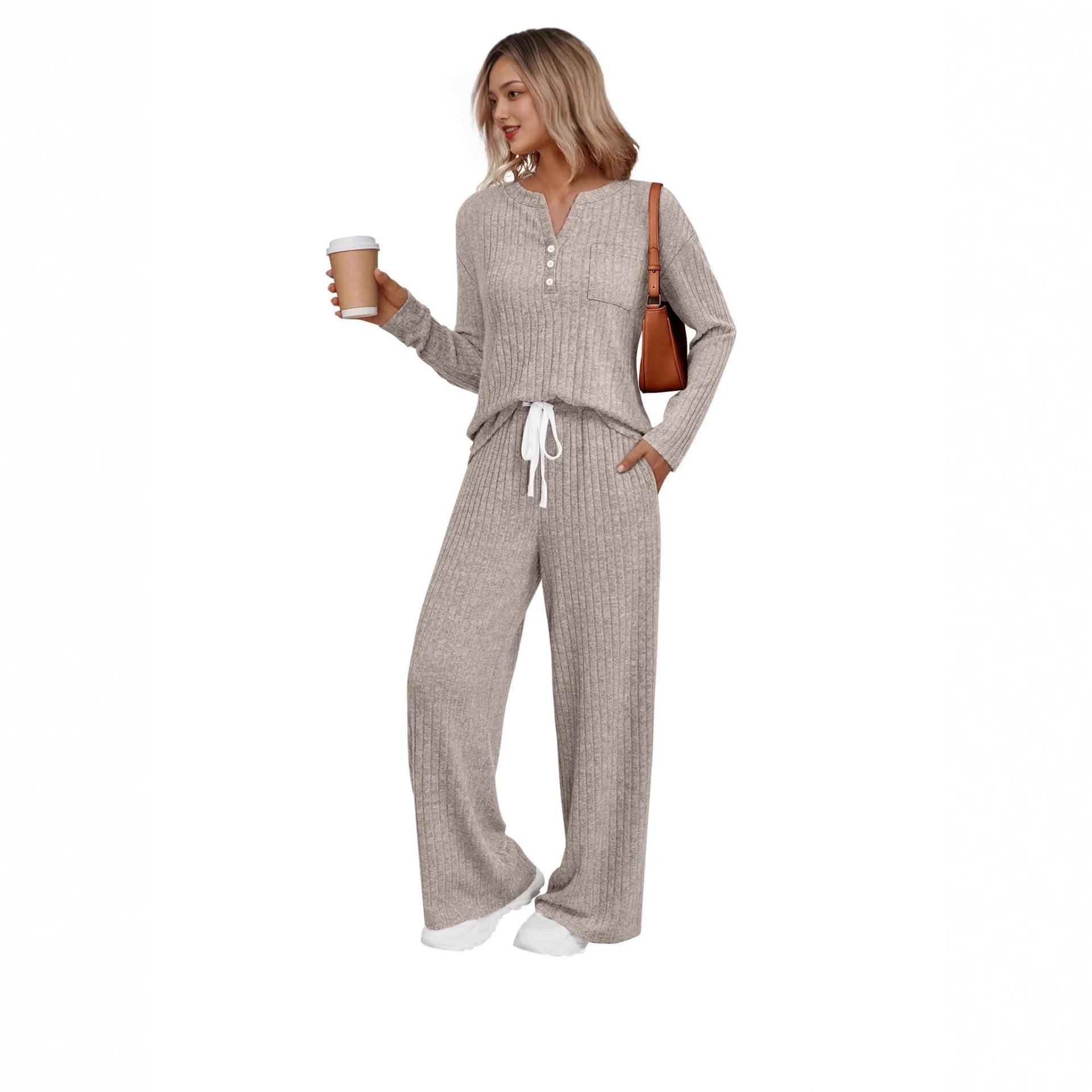 Woman wearing a striped V-neck knit long coat with lace-up detail and pants from a casual streetwear set.