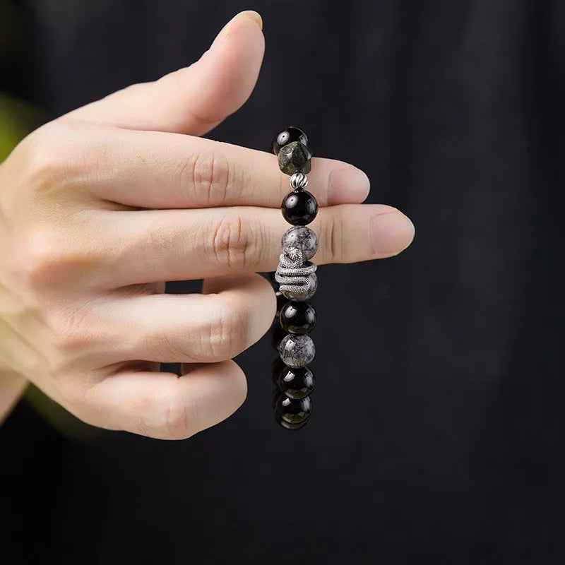Men's black obsidian and sterling silver snake bracelet with retro Zodiac design