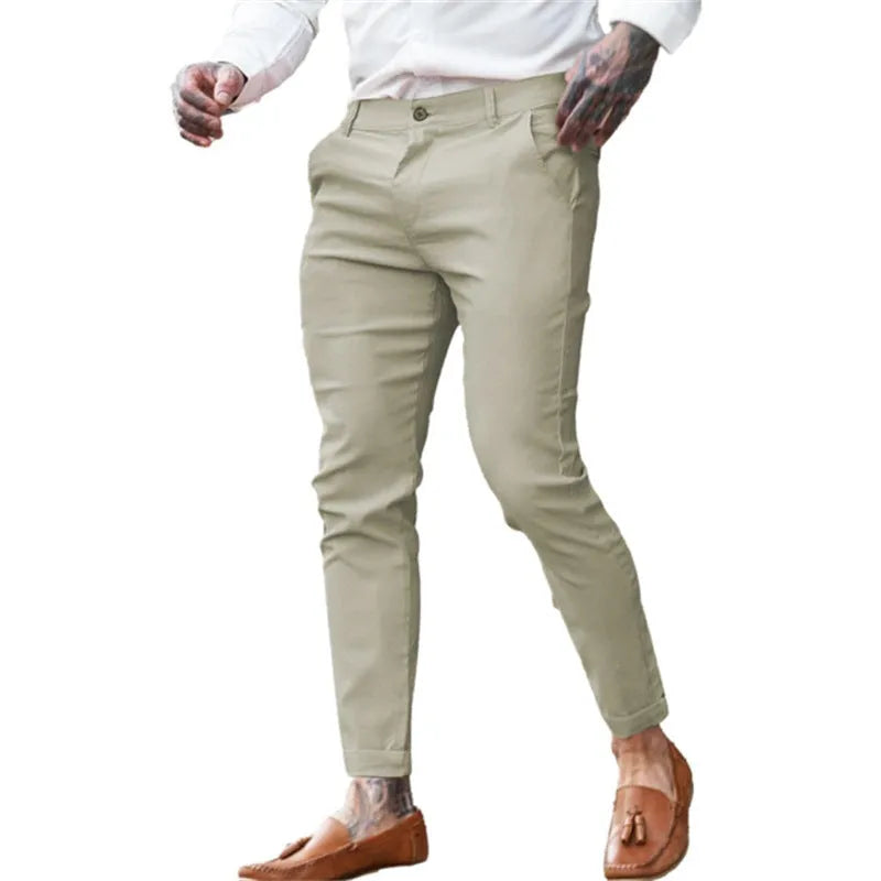 Men's slim fit stretch cotton twill pencil trousers on a hanger, shown in apricot colour.