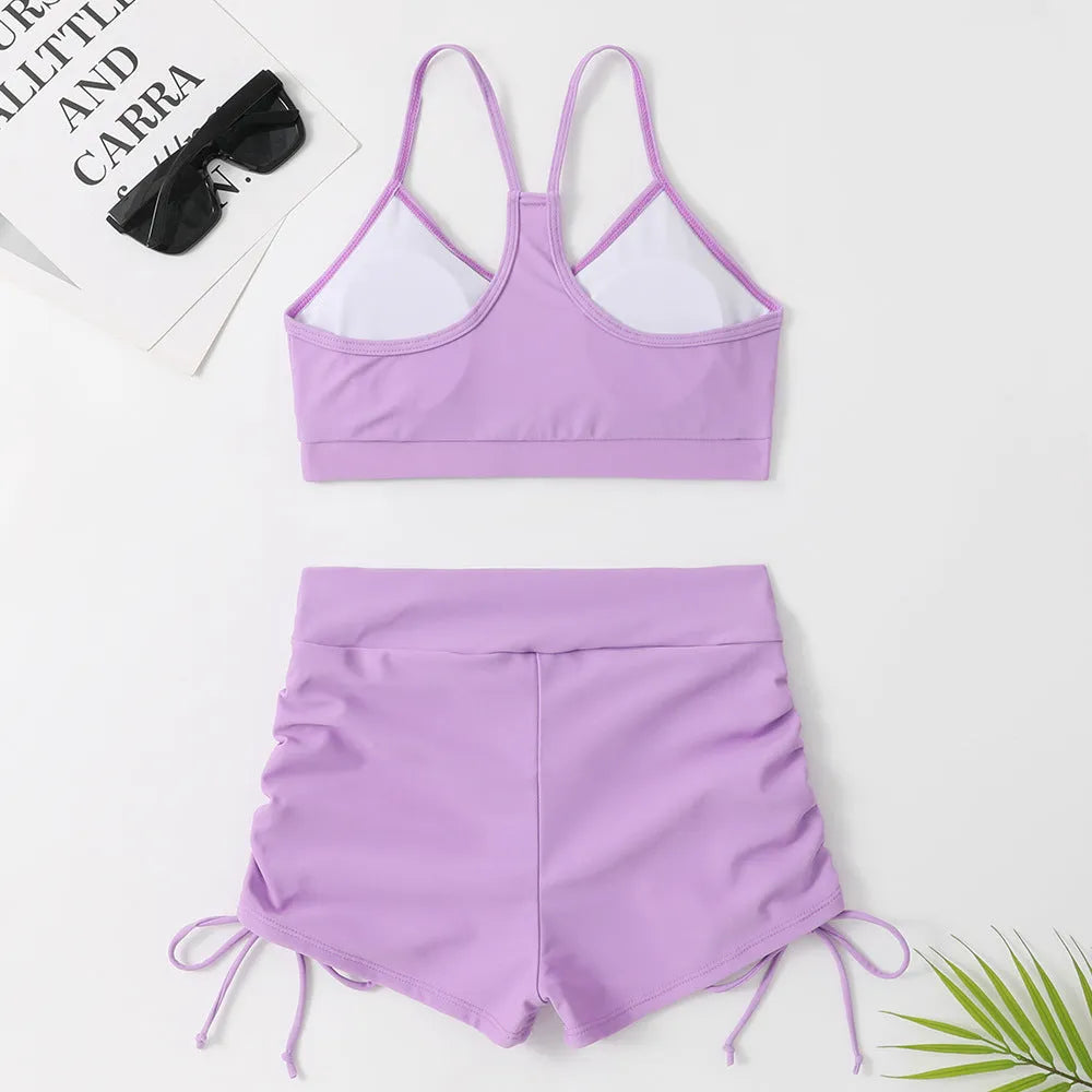 Purple women's high waisted bikini swimsuit with split side shorts and matching top