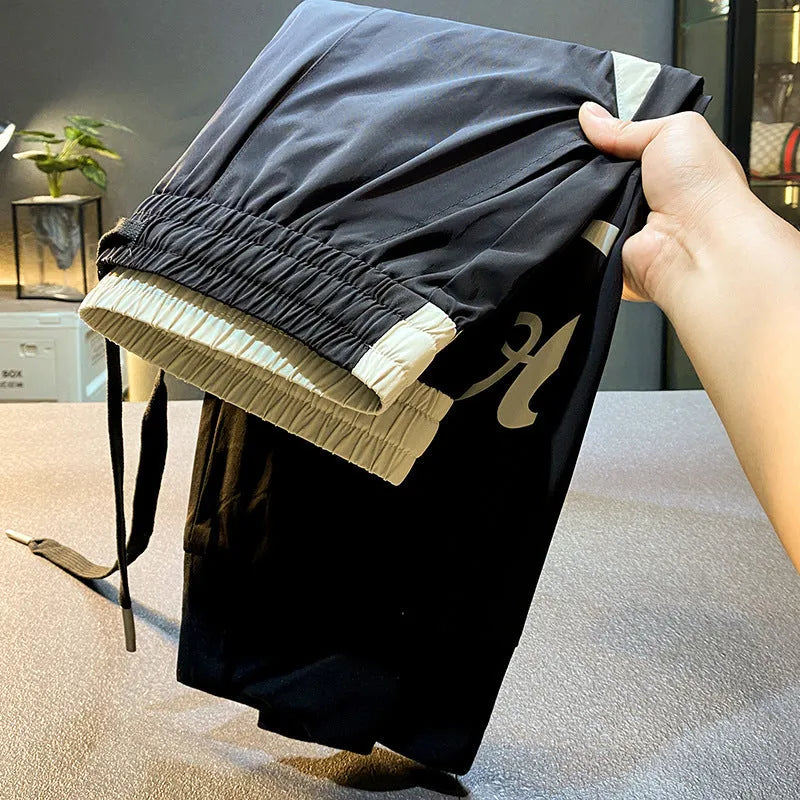 Black men's cropped casual trousers with an ankle band, made from ultra-thin cotton fabric.