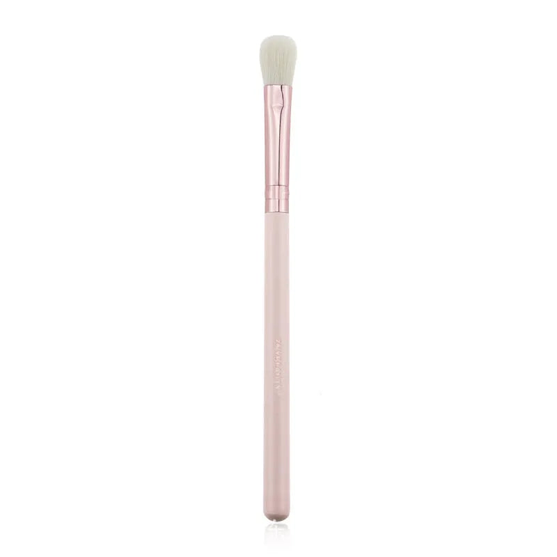 26 pink makeup brushes with wooden handles laid out next to a matching storage bag.