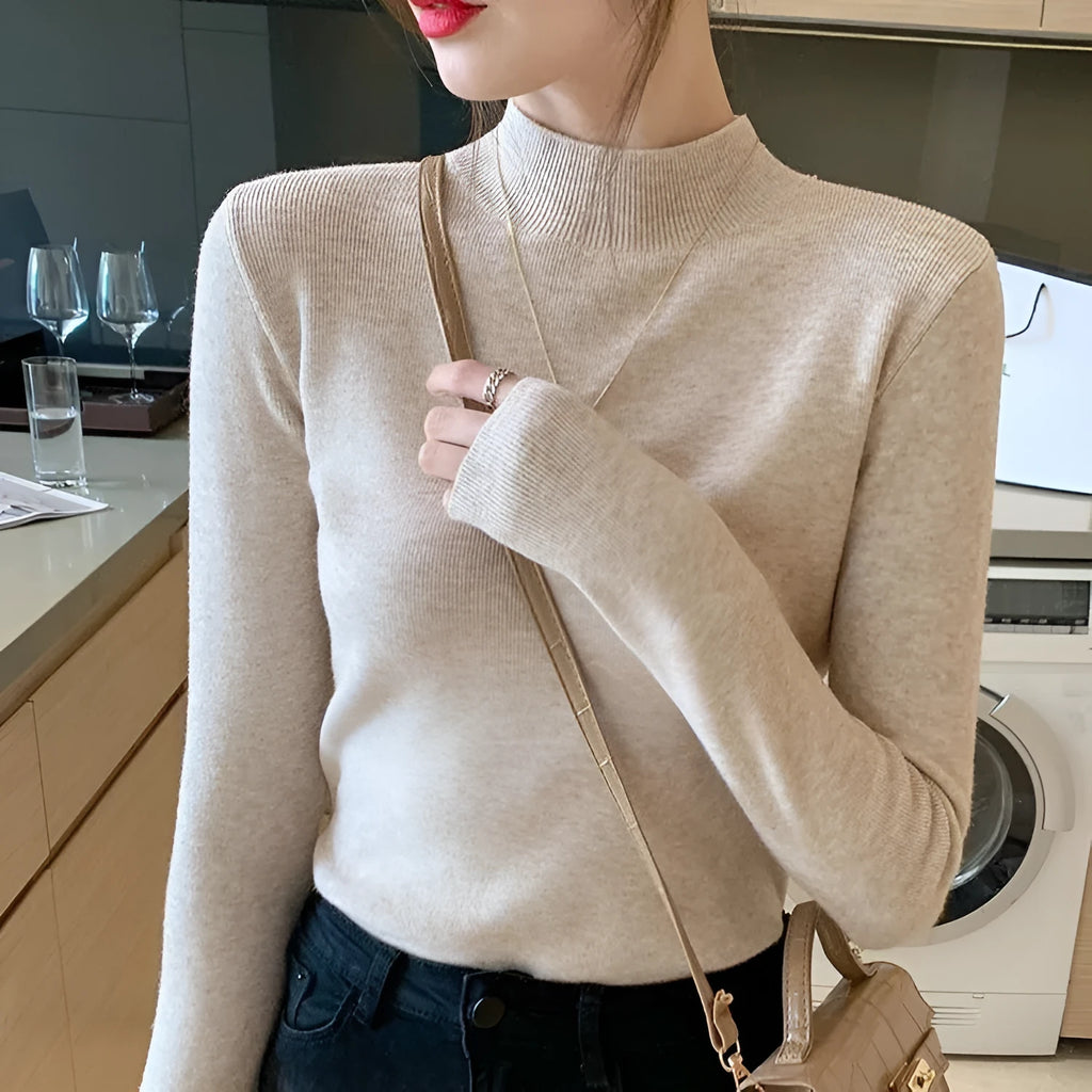 Slim fit knitted viscose bottoming shirt in a neutral colour with long sleeves, shown on a hanger.