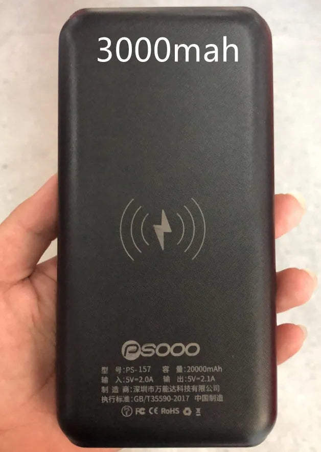 Black solar power bank with wireless Qi charging pad, three USB ports, and an LED flashlight