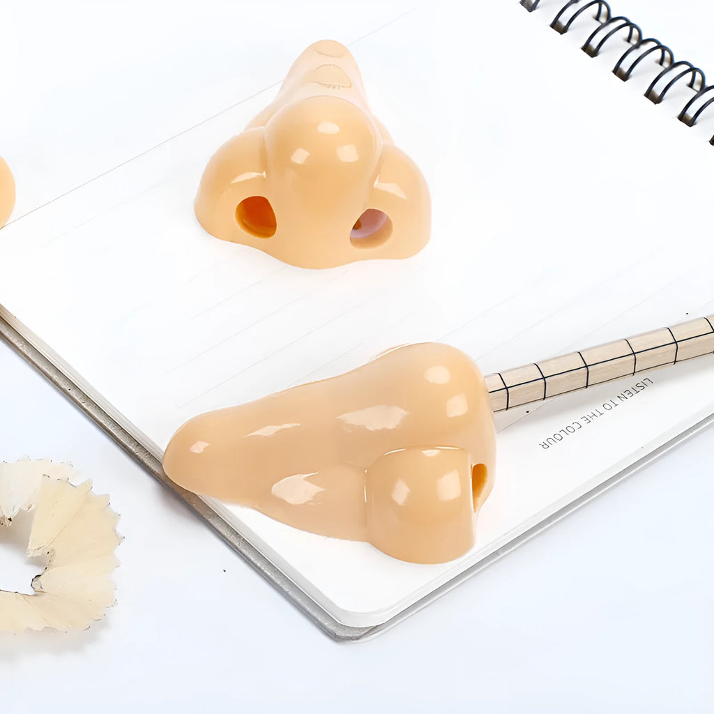Flesh colour plastic manual pencil sharpener with geometry shape measuring 58x45x30mm for student stationery