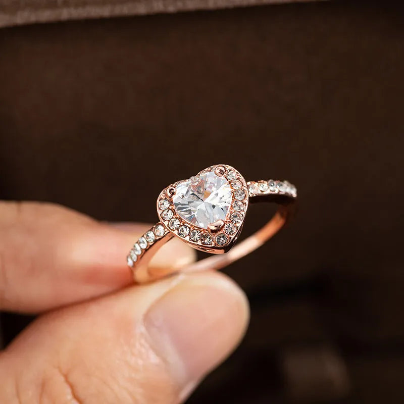 Women's heart-shaped crystal ring in rose gold or silver tone on a white background
