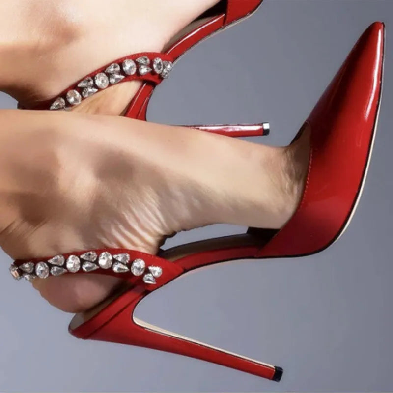 Women's pointed toe high heel sandals with rhinestone side detail on patent leather upper.