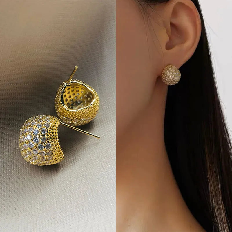 Geometric drop-shaped diamond ear clip earrings in gold and white colours with spherical elements