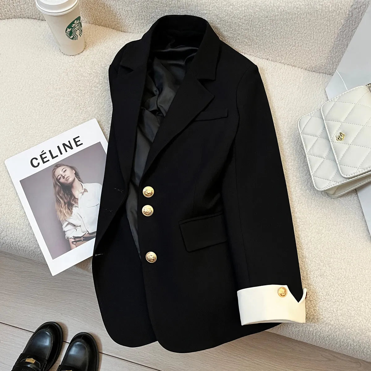 Milky white loose-fit women's trench coat with long sleeves and pockets on a hanger.