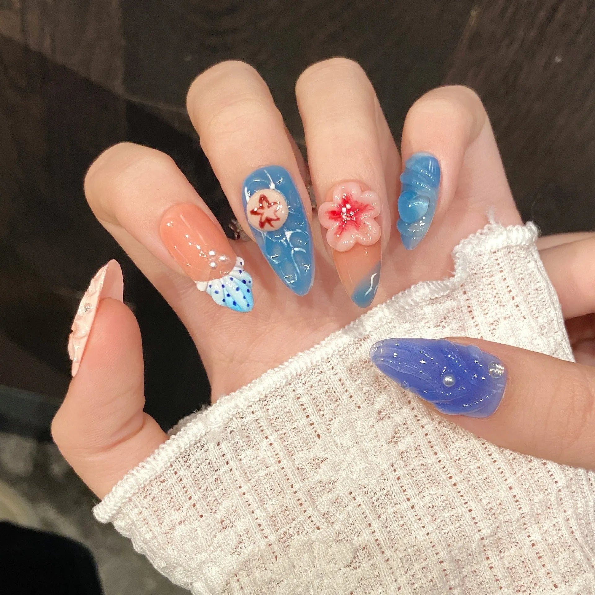 Plastic wearable armour with a carved three-dimensional jellyfish design in almond nail colour.