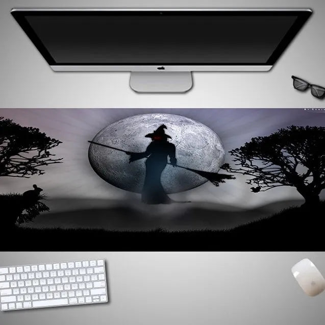 Oversized rectangular Halloween-themed mouse pad on a desk, showing non-slip rubber cloth base.
