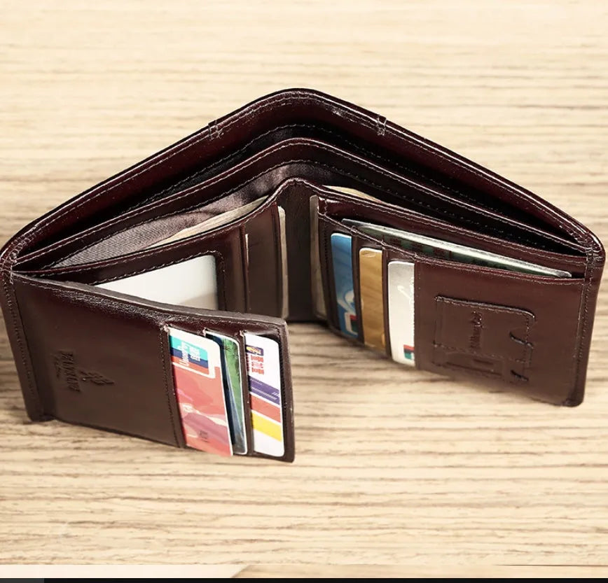 Men's black leather wallet open showing internal card slots, note compartment, and change section.