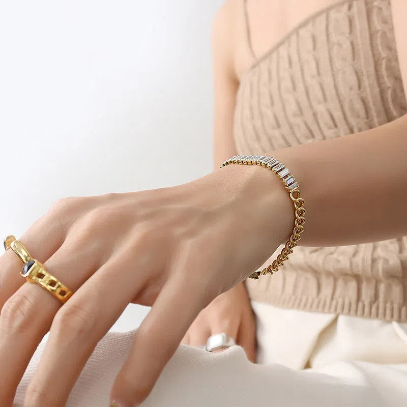 Gold titanium steel geometric matte finish unisex bracelet on flat surface