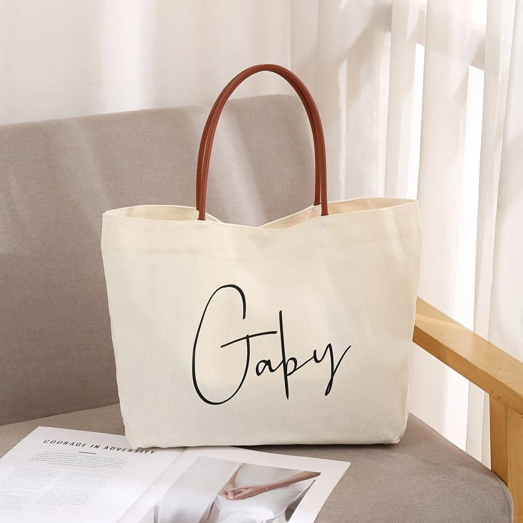 Heavy-duty cotton canvas tote bag with internal pockets, shown in beige white colour.
