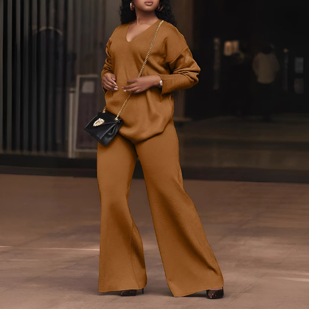 Women's brown suede two-piece suit with split sleeve top and matching trousers laid flat