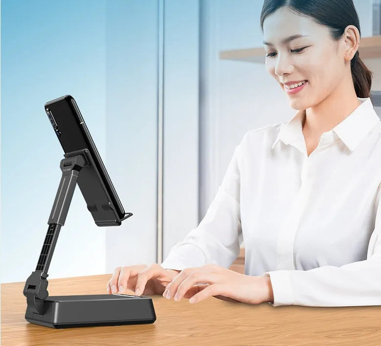 Black mobile phone broadcaster stand with Bluetooth speaker and microphone on desk