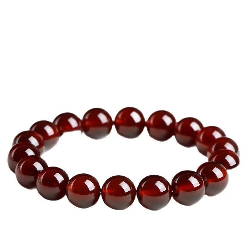 Natural orange red garnet crystal ball bracelet with a traditional metal Ruyi-style clasp.