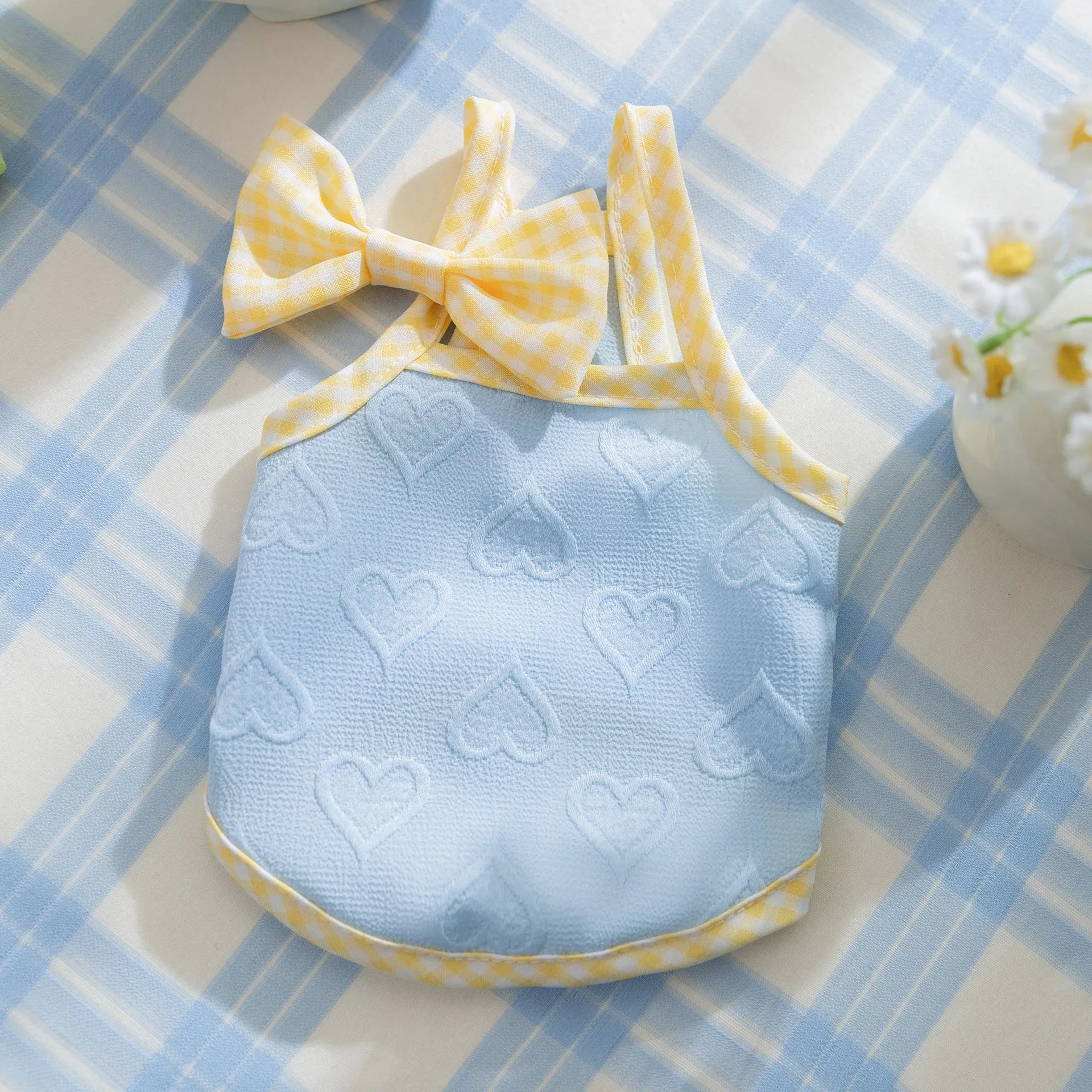 Small dog wearing elastic vest with heart texture and bow suspenders in Bondi Blue colour
