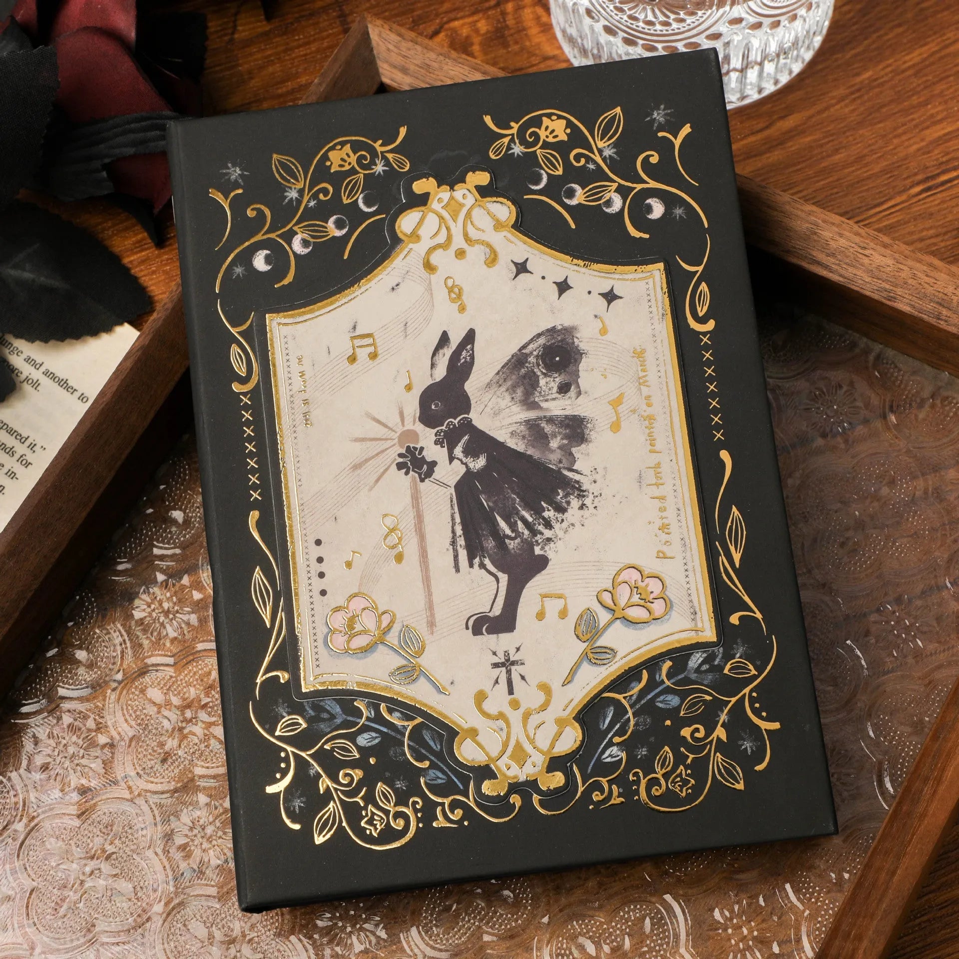 A5 retro Gothic art notebook with thematic cover, shown next to pen for scale
