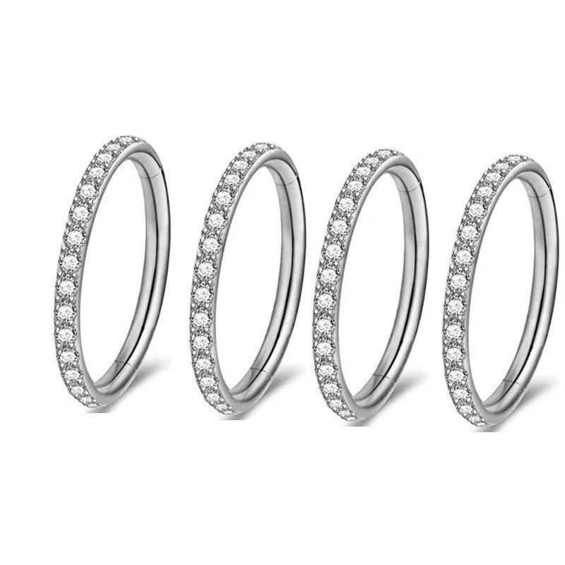 Close-up of a seamless round stainless steel nose ring with a diamond finish, showing colour options including gold, rose gold, and black.