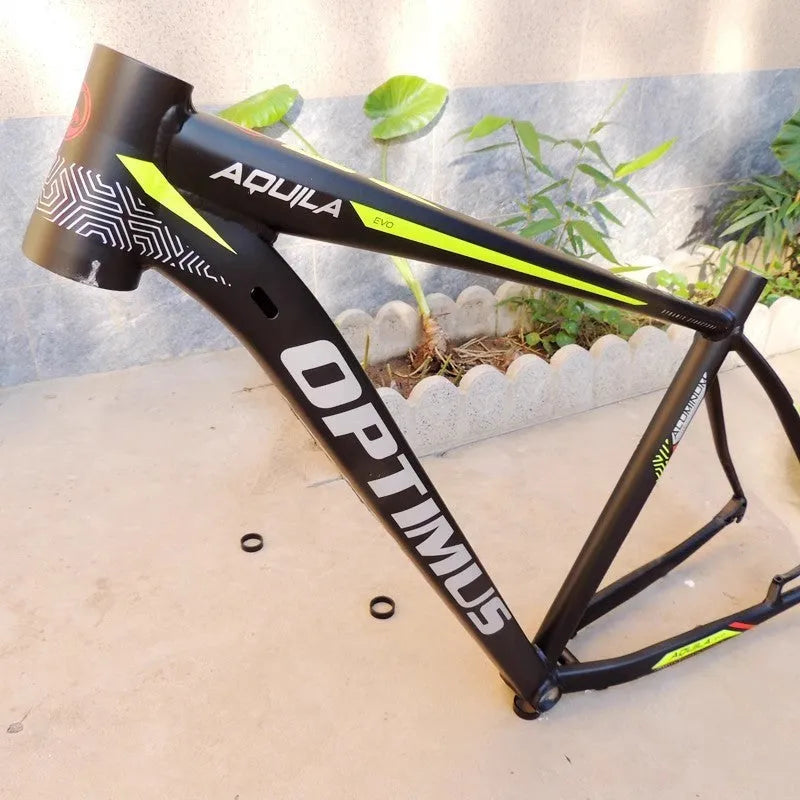 Black green 29-inch aluminium mountain bike frame showing internal cable ports and disc brake mount.