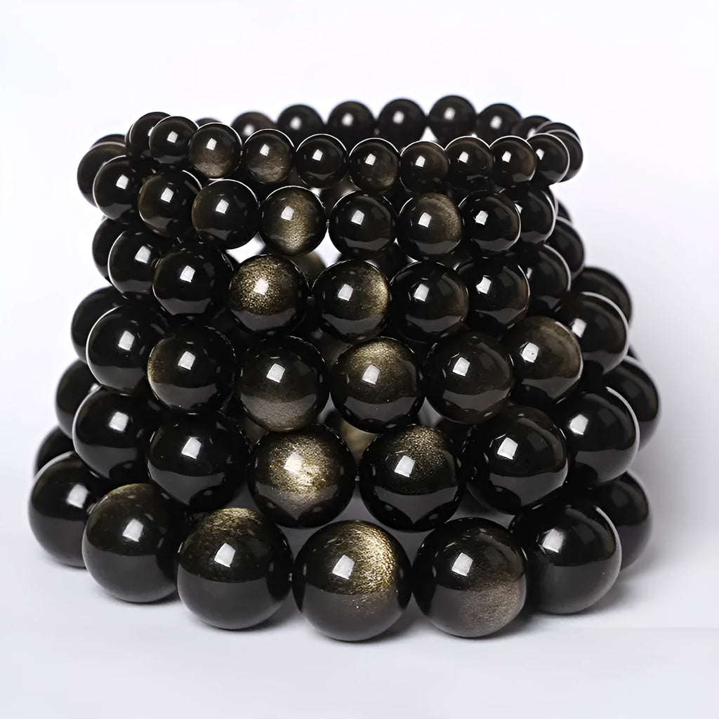 Hand-woven round obsidian bracelet with crystal beads in various colour options on a wrist.