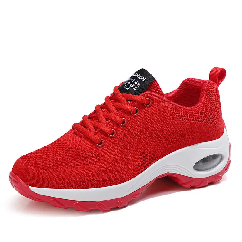 Women's red mesh sneakers with round toe and front lace-up design on flat surface