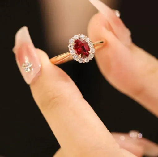 Sterling silver ring with gold pigeon design and red gemstone in floral pattern