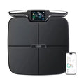 Black eight-electrode intelligent body fat weighing scale on a floor.