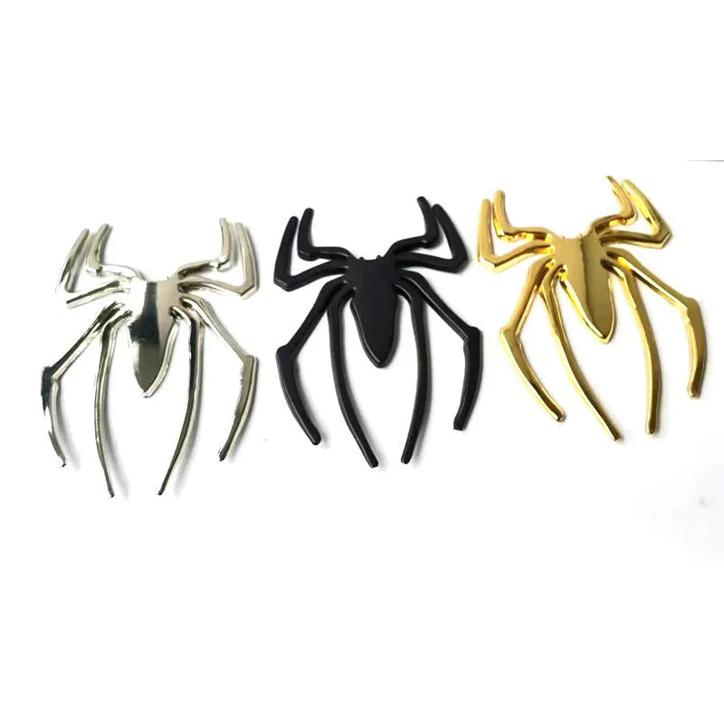 Three-dimensional metal spider car bumper sticker in zinc alloy, shown in gold colour.