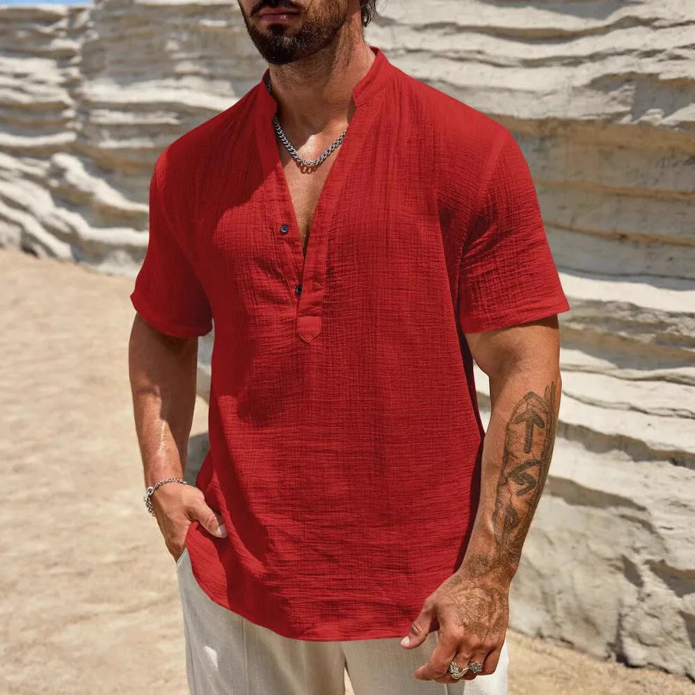 Man wearing a solid colour short sleeve casual shirt with a stand collar.