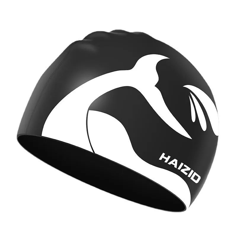 Silicone swimming cap with whale tail pattern and built-in ear protectors.