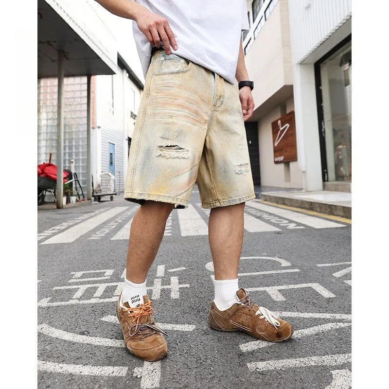 Men's light blue washed denim shorts with ripped details and a straight-leg cut