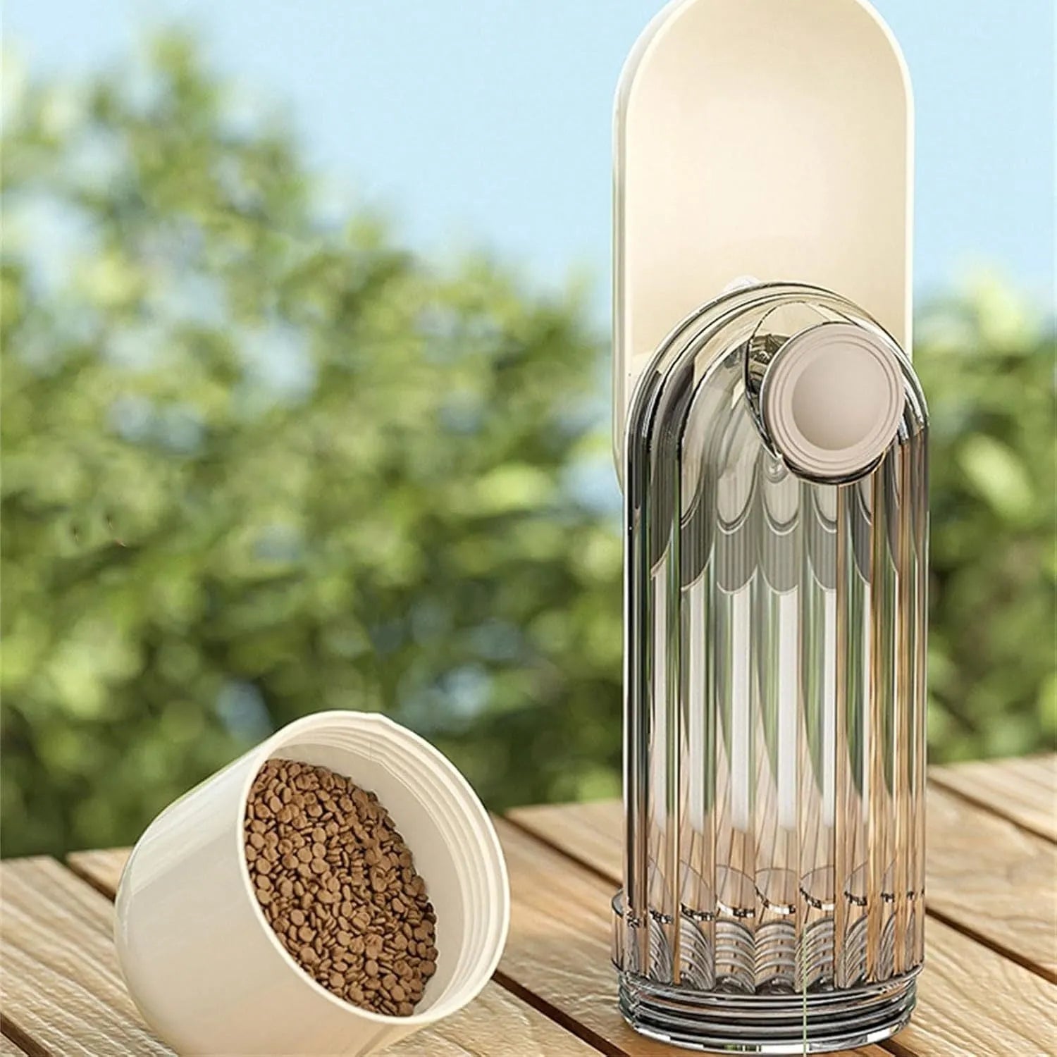 Beige and green foldable dog water bottle with food container, shown with press-to-dispense tray.