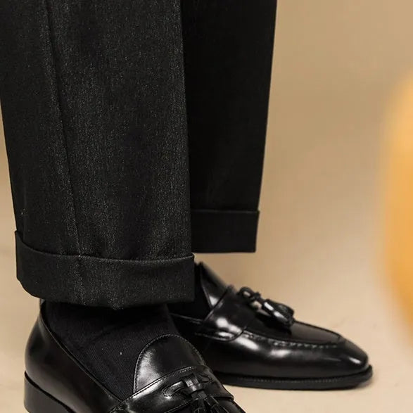 Men's leather tassel loafers in black and brown with polished finish and rubber soles