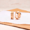 Rose gold circular women's earrings with a hollowed-out three-heart design.